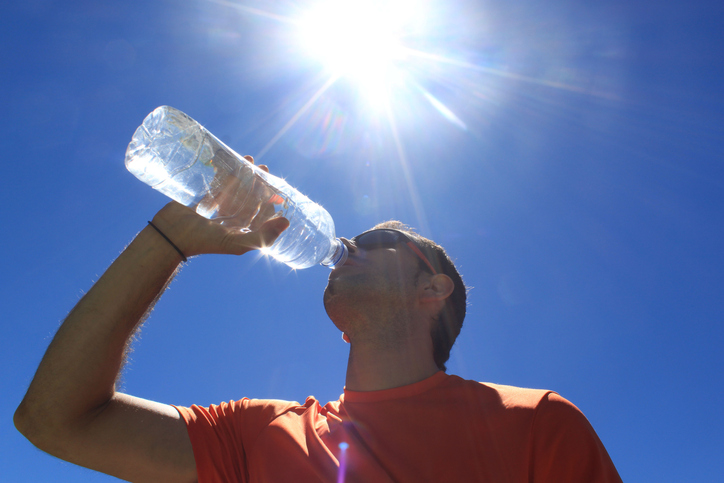 Man drinking water on a hot day Man drinking water on a hot day