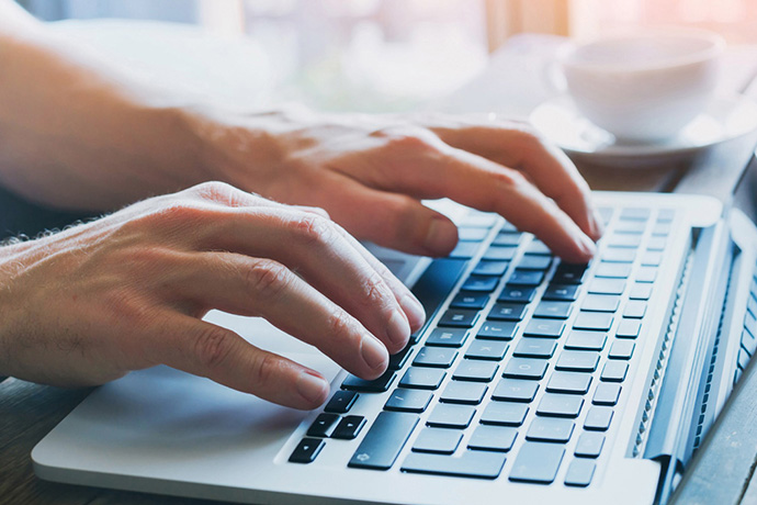 Person typing on laptop Person typing on laptop